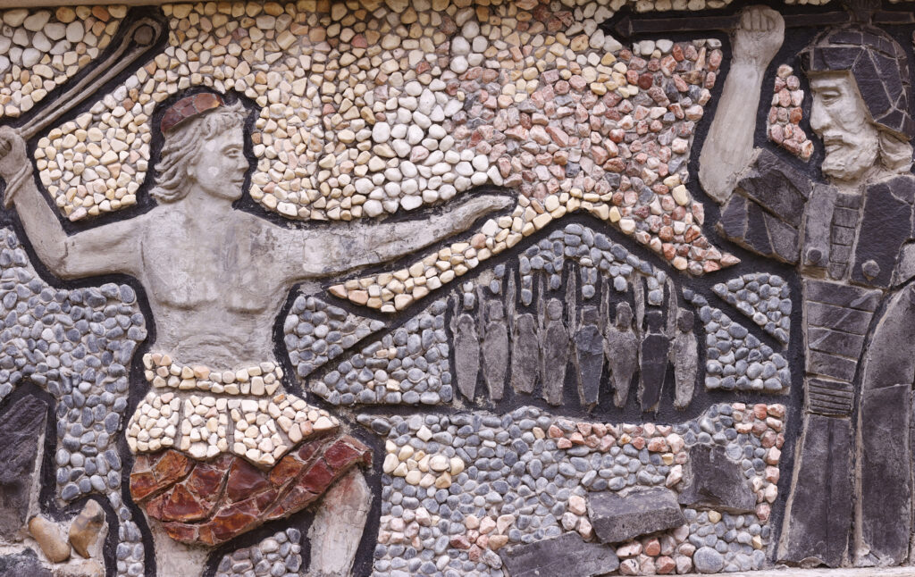 ancient mural of David and Goliat representing man vs. man classic conflict in a story